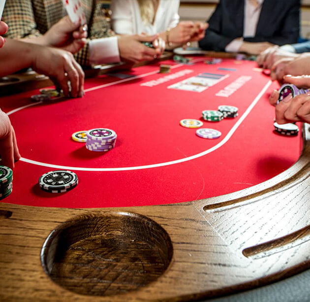 Close-up of a red poker table with chips during gameplay